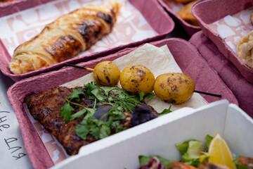 Here is a detailed closeup view of a beautifully arranged tray filled with various types of delicious food placed elegantly on a table, showcasing its vibrant presentation