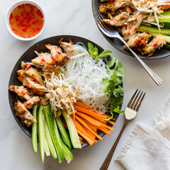 Servings of Vietnamese vermicelli and chicken bowls with nuoc mam dressing.