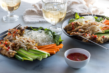Two servings of Vietnamese vermicelli bowls with nuoc mam dressing.