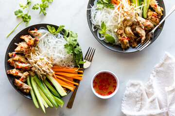 Rice vermicelli with lemongrass chicken bowls served with nuoc mam dressing.