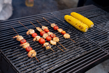 Delicious Grilled Skewers Featuring Cherry Tomatoes and Sweet Corn on the Cob for a Perfect Summer Meal