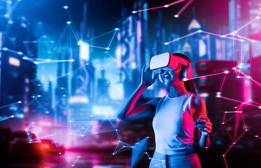 Female standing in cyberpunk style building in meta wear VR headset connecting metaverse, future cyberspace community technology. Woman touching goggle looking far virtual construction. Hallucination.