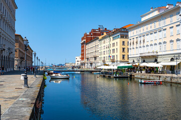 Grand Canal in Trieste Italy with bridges, boats and houses flowing into the sea