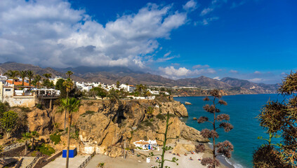 Little touristic town Nerja in Costa del Sol, Andalusia, Spain. It has many restaurants, bars and cafes. Aerial view of the beach