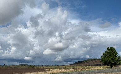 Gorgeous scenic view of Willamette Valley, mid Oregon. Stunning white clouds filling the bright blue sky over the rural countryside. 