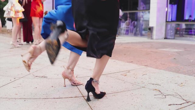 High school graduates dancing on prom, waltz and classical ball dance in dresses and suits on school graduation party, girls and boys classical ballroom dancers, couples dance quadrille and polonaise