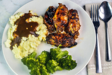 barbecue wings with  mash potatoes and gravy