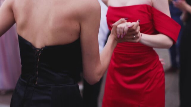 High school graduates dancing on prom, waltz and classical ball dance in dresses and suits on school graduation party, girls and boys classical ballroom dancers, couples dance quadrille and polonaise