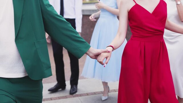 High school graduates dancing on prom, waltz and classical ball dance in dresses and suits on school graduation party, girls and boys classical ballroom dancers, couples dance quadrille and polonaise