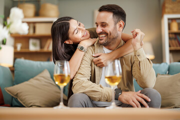 Laughing, love and couple with wine at home!