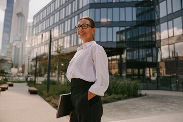 Confident and empowered businesswoman thriving outdoors in a vibrant urban environment today