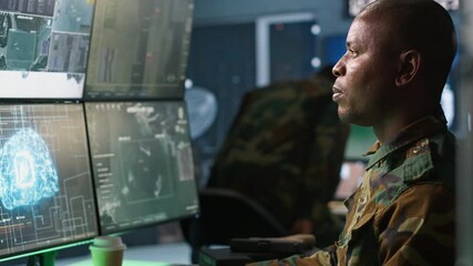 Army professional employing AI tech to improve military combat systems and missiles monitoring. African american IT admin uses neural networks to enhance combat operational capabilities, camera A