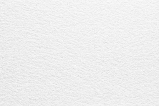 Close-up of seamless white watercolor paper texture background with subtle, natural patterns and a smooth finish. Ideal for creative projects requiring clean, artistic paper surfaces.