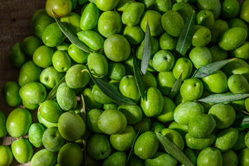 green olives with leaves as background