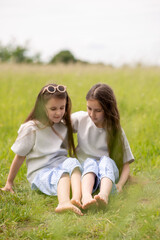 two sisters sitting on the grass