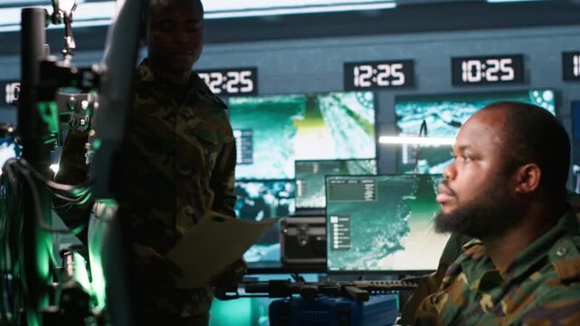 Military agents in war room look at intel folder files on enemy battle formation. Intelligence agency professionals read mission case file to collect data on opponents strategy, camera A