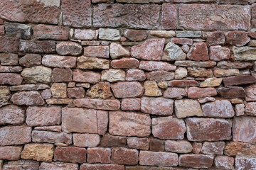 Une matière de vieux mur de pierres rouges