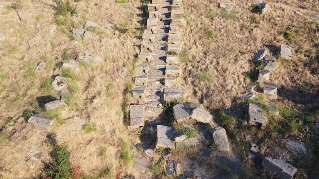 Overgrown amphitheater on the Turkish Aegean coast. Here the village of Ildır, formerly Erythrai, whose amphitheater is flown over by a drone.