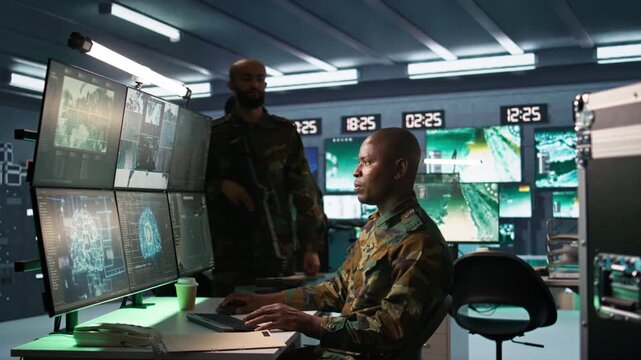 Army professional employing AI tech to improve military combat systems and missiles monitoring. African american IT admin uses neural networks to enhance combat operational capabilities, camera B