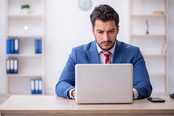 Young male employee working in the office