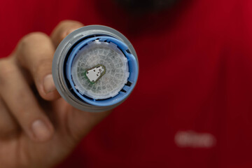 Close-up of a girl applying a glucose monitoring patch on her arm