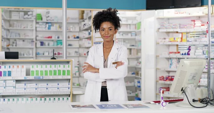 Pharmacist, woman and arms crossed for healthcare service, medicine help desk and store management. Professional face of medical worker or an african doctor at a pharmacy, cash register or computer