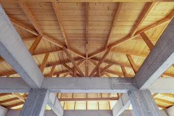 Wooden roof ceiling detail. Interior view of a wooden roof structure.