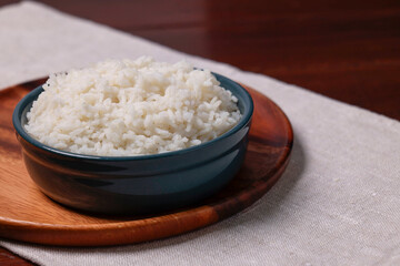 Delicious boiled rice served on table. Space for text