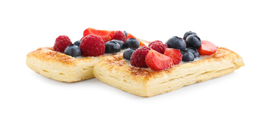 Tasty puff pastries with berries isolated on white