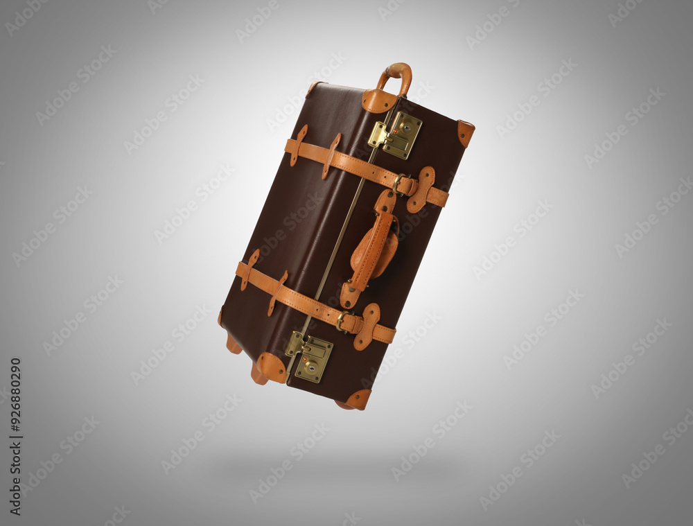 Sticker Vintage suitcase in air on light grey background