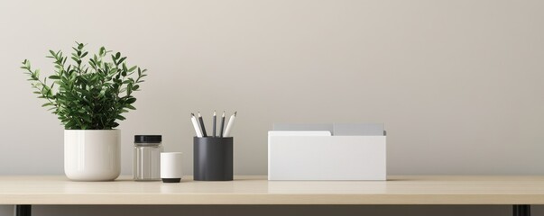 Minimalistic workspace featuring a plant, stationery holder, and a tidy arrangement on a wooden desk against a neutral background.