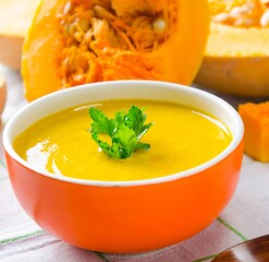 Pumpkin soup served on the table in bowl