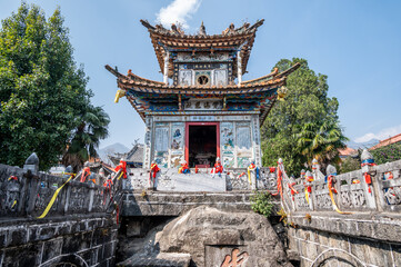 Fototapeta premium An exquisite Guanyin shrine on a huge stone lying under the pond water in Guanyin Tang temple in Dali town of China.