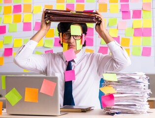 Young employee in conflicting priorities concept