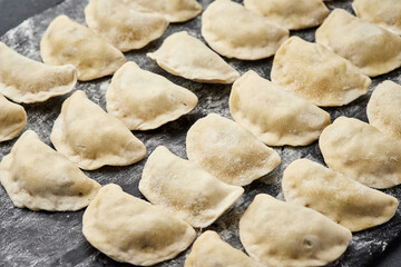 Freshly prepared homemade dumplings ready for cooking, showcasing traditional culinary skills