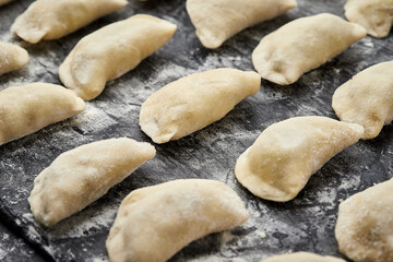 Freshly prepared homemade dumplings ready for cooking, showcasing traditional culinary skills