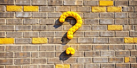 Yellow question marks symbolizing confusion in front of a gray brick wall, question marks, yellow, gray, background