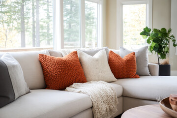 Modern house interior living room sofa with orange chunky knit pillows