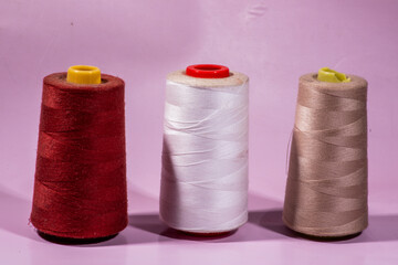 sewing accessories on a pink background