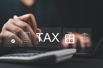 Businessman using the laptop to fill in the income tax online return form for payment. Financial...