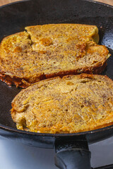Cooking french toast in a pan on butter