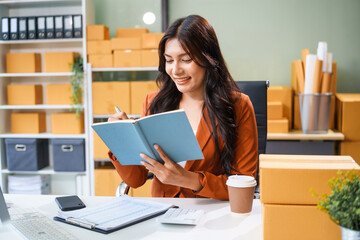 A young Asian businesswoman sits at her table, watching the computer screen.She analyzes, plans,...