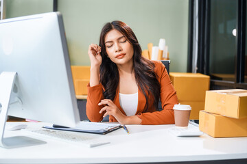A businesswoman sits at the table, stressed as she works to sell products online. Sales are poor, losses mount, the market is quiet, customers disappear, and targets are not reached.