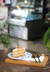 Carrot cake in plate on table at cafe