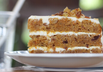 Carrot cake in plate on table at cafe