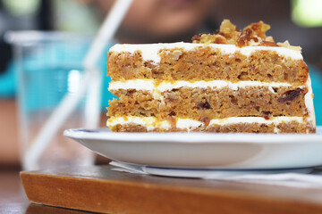 Carrot cake in plate on table at cafe
