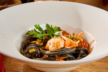 Fried Black Noodle Lagman with Vegetables in a White Plate