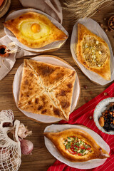 Assorted Georgian Pastries Khachapuri and Penovani Arrangement on Rustic Table