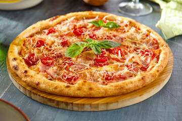 Delicious Fresh Pizza with Tomatoes and Bacon on Wooden Board