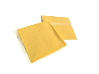 Two pieces of processed cheese slice for burger in a plastic wrapping package isolated on white background